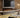 Panoramic electric fire with realistic flames and wood wall panelling
